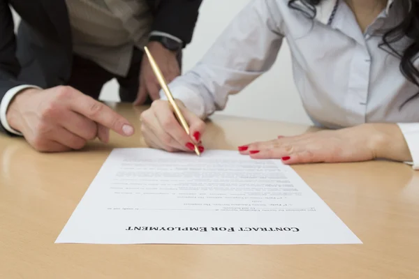 Employer showing new employee where to sign employment contract — Stock Photo, Image