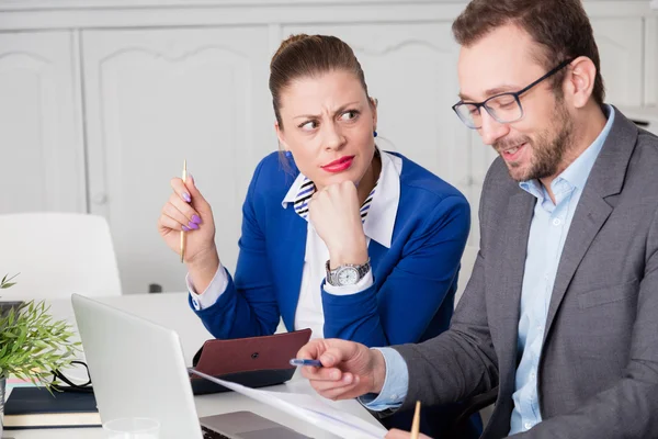 Businesswoman does not approve the humor of her male colleague