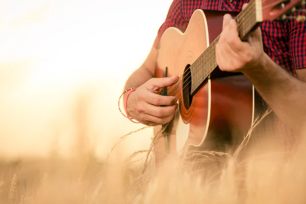 Adam sahada akustik gitar çalmak 