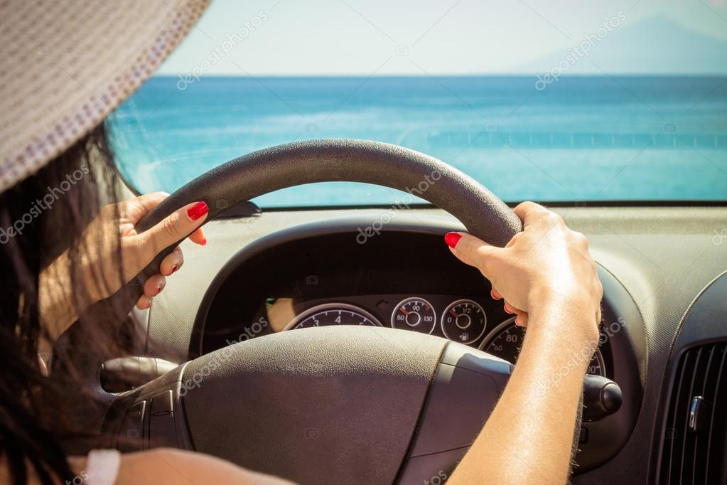 Close up of female hands on steering wheel — Stock Photo © Zoffphoto