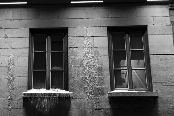 Montreal 'deki Jacques Cartier meydanında loş ışık ve biraz kar olan iki simetrik pencere.