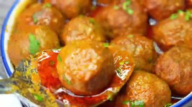 Kofta körili baharatlı baharatlı ve bol soslu, aromatik aromalı sıcak servis edilen baharatlı köfteler. Hint yemekleri görsel, restoran menüleri ve ticari stok görüntüleri için ideal..