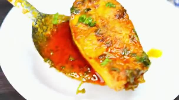 Traditional fish curry prepared with spices and gravy served hot in home style Indian presentation. Perfect for seafood menus cultural food visuals and commercial stock footage showcasing classic fish dishes. Traditional fish curry prepared with spices and gravy served hot in home style Indian presentation. Perfect for seafood menus cultural food visuals and commercial stock footage showcasing classic fish dishes.