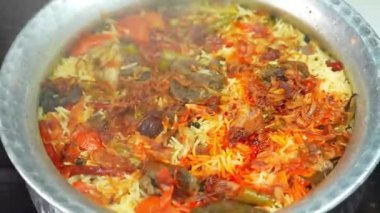 Uzun tahıllı basmati pilavı ve taze etle pişirilmiş ve aromalı sıcak servis edilen koyun eti biryani. Restoran menüleri, aile yemeği görselleri ve biryani yemeklerinin yer aldığı ticari stok görüntüleri için ideal..