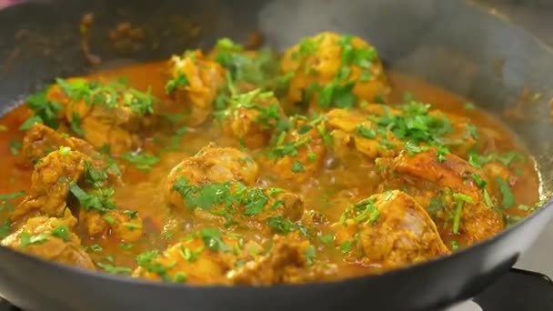 Sizzling chicken curry cooked with spices and rich gravy served hot as a bold and flavorful main course for restaurant menus and stock footage.