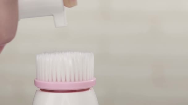 Cosmetische crème op gezicht reinigende borstel — Stockvideo