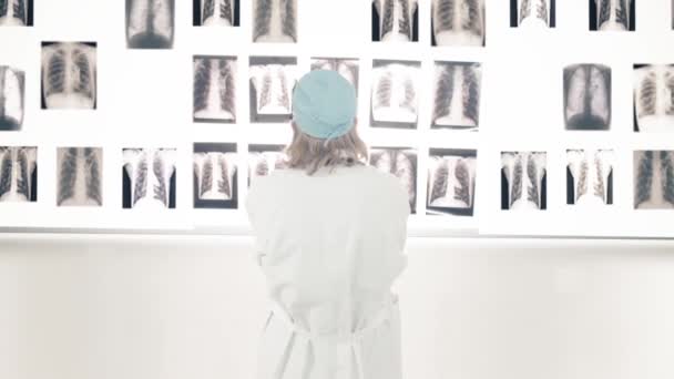 Doctor mirando rayos X en la pared — Vídeos de Stock