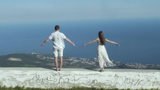 Casal jovem em pé em Rocky Cliff — Vídeo de Stock