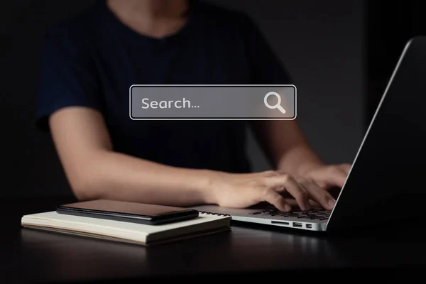 stock image Woman using laptop for searching with browser icon hologram effect.