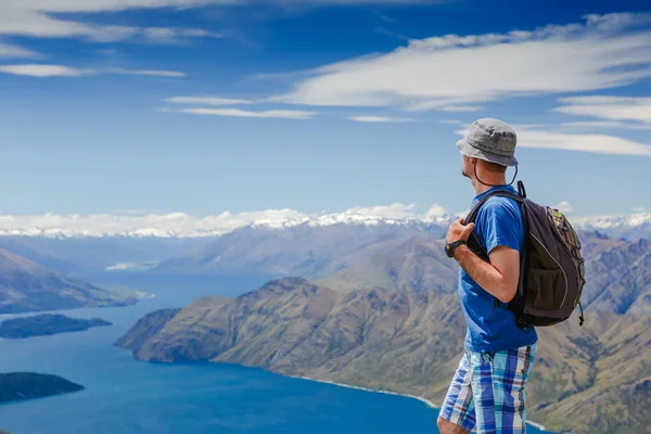 Turista com mochila e panorama de montanha — Fotografia de Stock