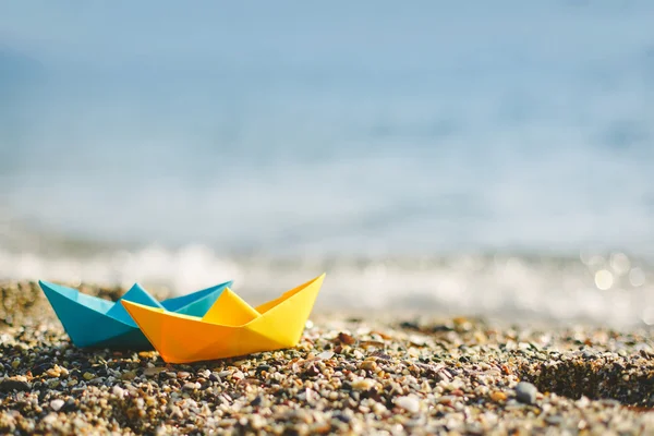 Paper boats on beach — Stock Photo, Image