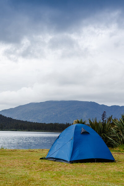 camping tent over mountain lake 