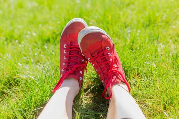 Feet in red sneakers — Stock Photo, Image