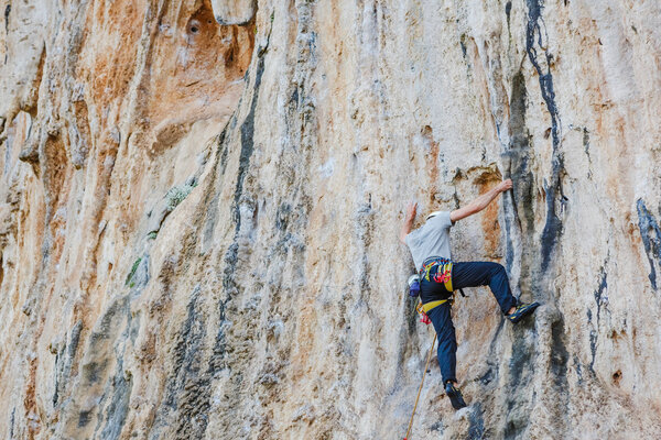 Young man climbing on a wall