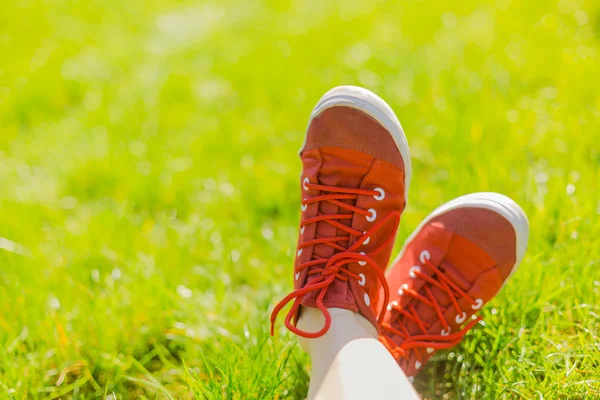 Feet in red sneakers — Stock Photo, Image
