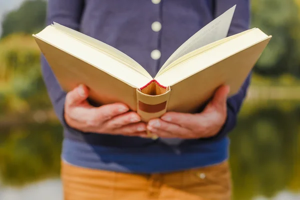 Female hands holding open book — Stock Photo, Image