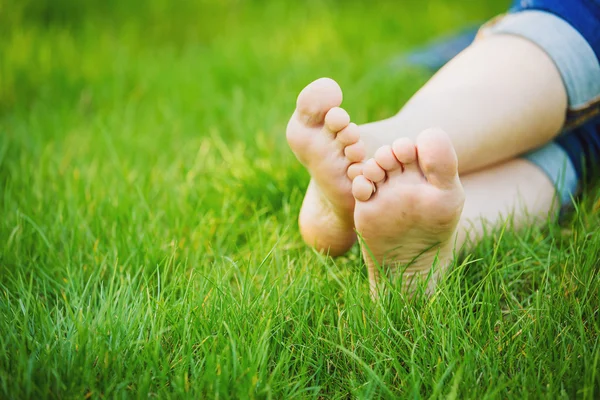 Weibliche nackte Füße im Gras — Stockfoto