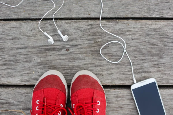 red sneakers and smart phone