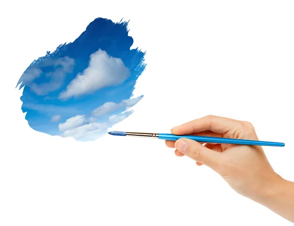 Hand with brush and sky paint — Stock Photo, Image