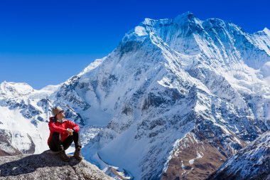 hiker sitting in Himalayas mountains clipart
