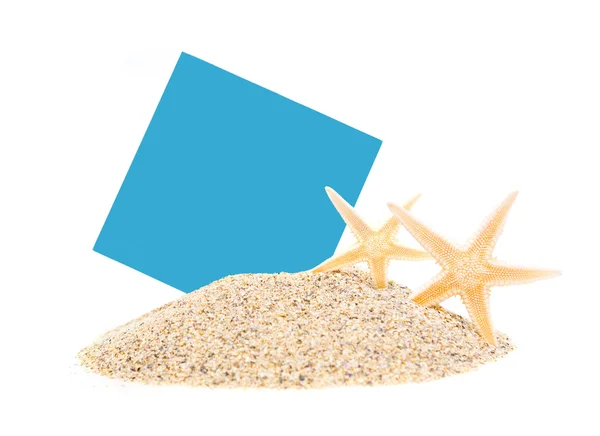 Sand with starfishes and blank blue paper — Stock Photo, Image