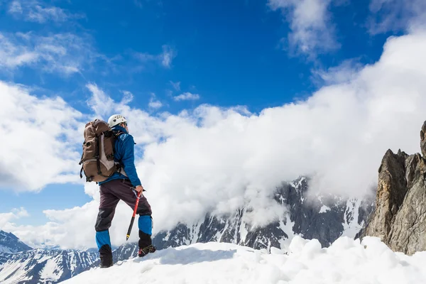 Bergsteiger erreicht die Spitze eines Berges — Stockfoto