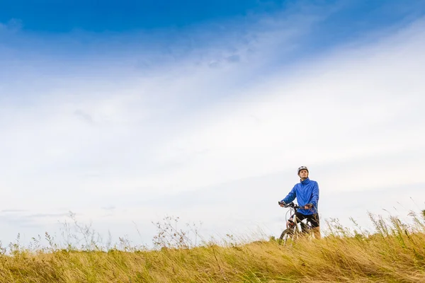 Junger Mann mit stehendem Fahrrad — Stockfoto