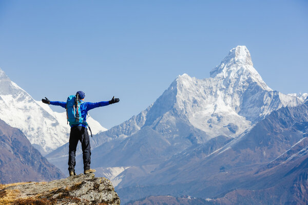 Hiker enjoying the view on the Everest trek in Himalayas, Ama Dablam mountain view, Nepal