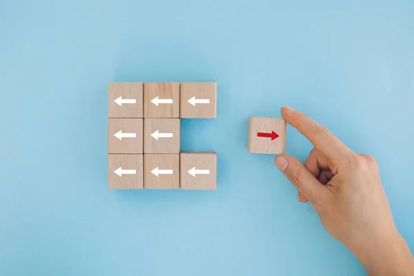 Female Hand Placing Pulling Red Block Different Direction Arrow White — Zdjęcie stockowe