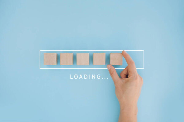 Loading, hand putting wood cube in progress bar