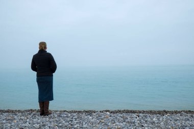 Sisli denize bakan bir kadın
