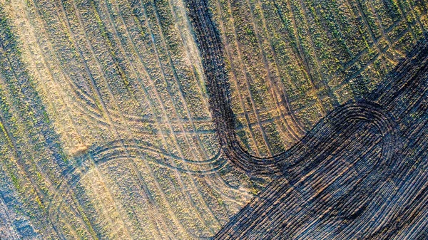 stock image Aerial view geometric farming fields, showing a green meadow and plowed fields, captured with a drone