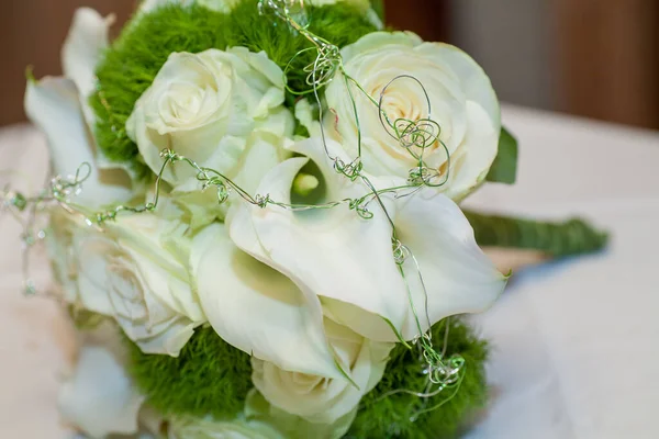 Fechar vista sobre flores calla com anéis de casamento em cores quentes — Fotografia de Stock