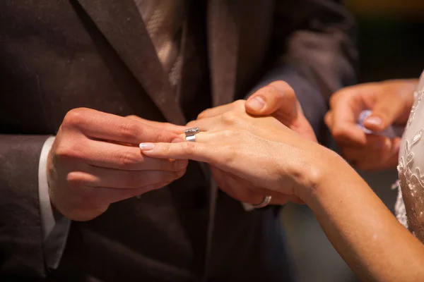 Close up of loving bride and groom putting a beautiful wedding ring to the beloved partner, marry me concept — Stock Photo, Image