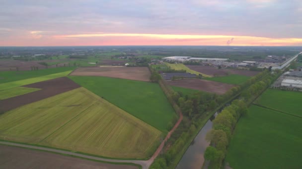 Countryside dramatic and colorful sunset flight over a forest lake, aerial shot on a drone — Stock Video