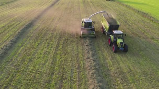 Male, Belgium, 18-09-2021, Aerial of tractor baler making slaw bales in field after fat warage in summer on farm — Αρχείο Βίντεο