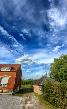 Bergnicourt, Rethel, Ardennes, Grand-Est, France, August, 28th, 2025,A beautifully picturesque countryside scene showcasing a vibrant and colorful sky along with charming rustic structures