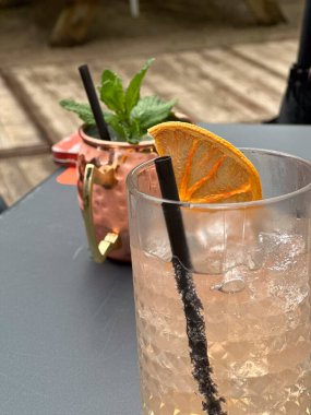 Enjoy two vibrant and colorful cocktails with lovely garnishes, ideal for outdoor gatherings and celebrations