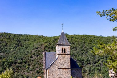 Esch-sur-Sure, Wiltz, Grand-Duche de Lüksemburg, Eylül 07, 2025, manzaralı kırsal kilise, Idyllic kırsal sığınağı, kayrak çan kulesi ve canlı doğal haliyle tepelere tünemiş.