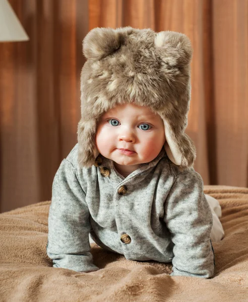 Beautiful baby in a fur hat — Stock Photo, Image