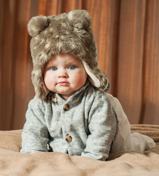 Beautiful baby in a fur hat — Stock Photo, Image