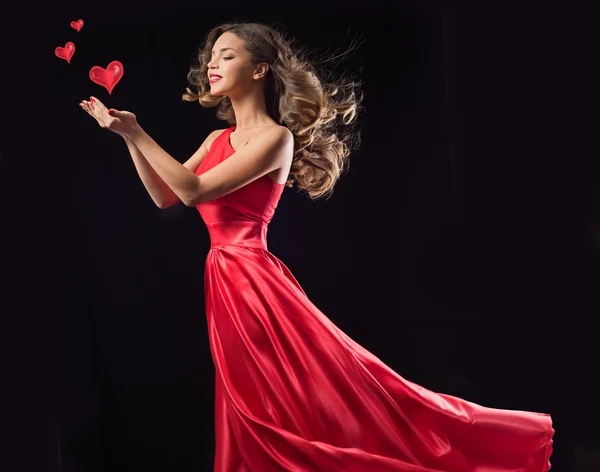 Young woman in red flying dress