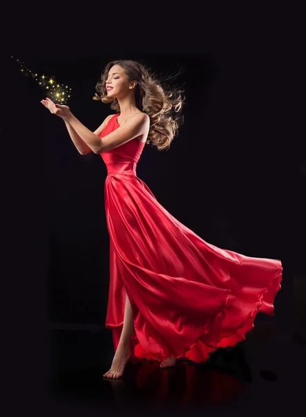 Young woman in red flying dress