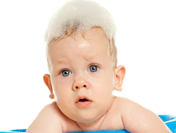Baby sitting in a blue tub — Stock Photo, Image