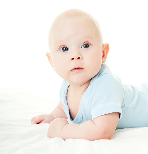 Cheerful baby on a bed — Stock Photo, Image