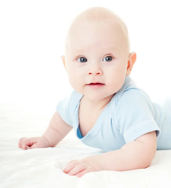 Cheerful baby on a bed Royalty Free Stock Images