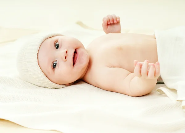 Cheerful baby on a bed — Stock Photo, Image