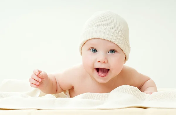 Cheerful baby on a bed — Stock Photo, Image