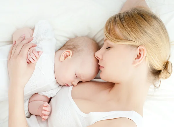 젊은 어머니와 그녀의 아기 침대에서 자 고 — 스톡 사진