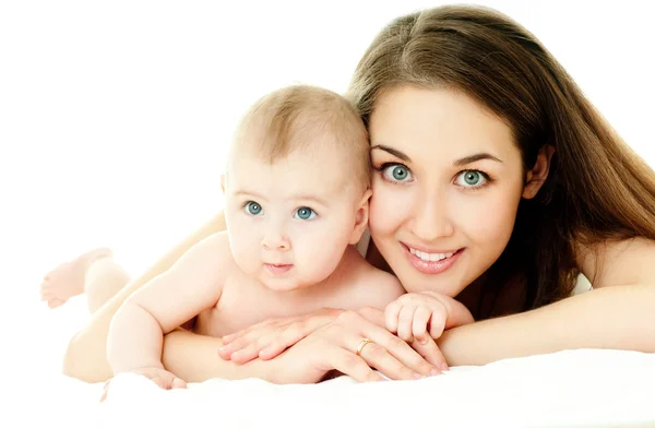 Mother and baby playing at bed — Stock Photo, Image